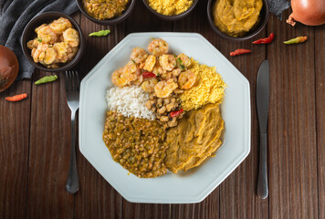 Caruru. Traditional Afro-Brazilian dish made with okra and dried shrimp, accompanied by vatapa, beans, rice, shrimp and farofa.