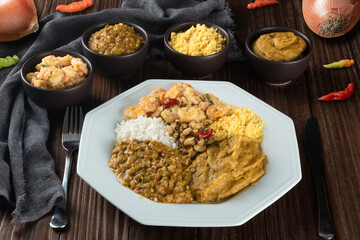 Caruru. Traditional Afro-Brazilian dish made with okra and dried shrimp, accompanied by vatapa, beans, rice, shrimp and farofa.