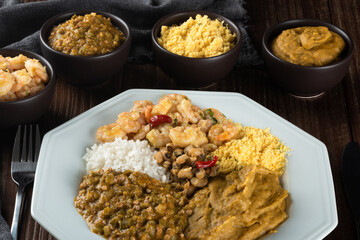 Caruru. Traditional Afro-Brazilian dish made with okra and dried shrimp, accompanied by vatapa, beans, rice, shrimp and farofa.