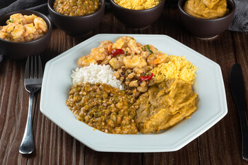 Caruru. Traditional Afro-Brazilian dish made with okra and dried shrimp, accompanied by vatapa, beans, rice, shrimp and farofa.