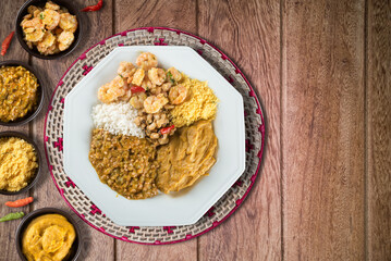 Caruru. Traditional Afro-Brazilian dish made with okra and dried shrimp, accompanied by vatapa, beans, rice, shrimp and farofa.