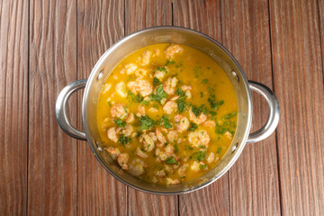 Shrimp moqueca in aluminum pan top view. Brazilian traditional food