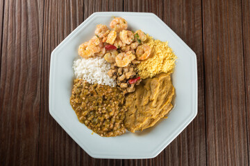 Caruru. Traditional Afro-Brazilian dish made with okra and dried shrimp, accompanied by vatapa, beans, rice, shrimp and farofa.