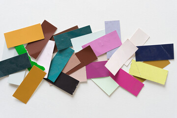 heap of paint sample pieces on a white ground