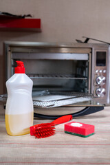 Dirty oven electric oven and items for washing and cleaning detergent sponge brush. High quality photo