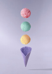 Gelato ice cream cone with colorful balls of ice cream falling. Abstract Infographic design of ice cream.Food deconstructed food styling concept.Trendy collage, creative art minimal aesthetic