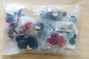 old buttons inside a grungy plastic bag
