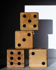 four large wooden dice stacked up white background