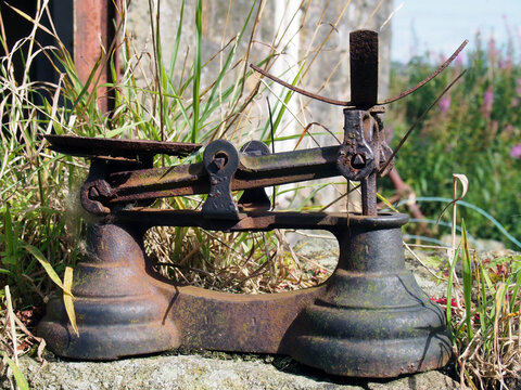 Old rusty balance weighing scales outdoors in a country setting