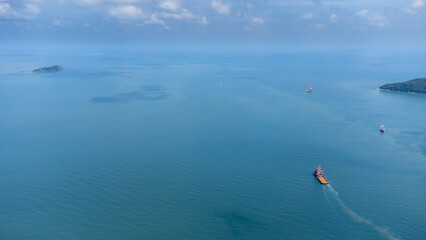 Obraz premium Aerial side on top view of cargo ship carrying container and running for export cargo yard port to custom in international ocean.