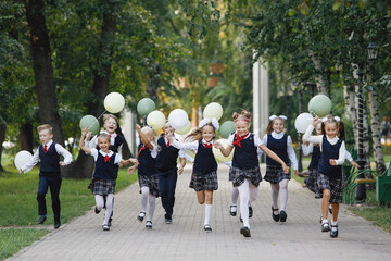 Schoolchildren run with balloons