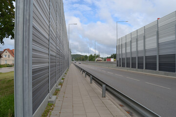 A noise barrier (also called a soundwall, noise wall, sound berm, sound barrier, or acoustical...