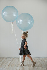 Girl with balloons in the interior
