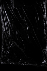 Black transparent plastic wrap texture overlay background. Realistic plastic for poster design and...