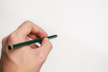Holding a pencil over blank paper