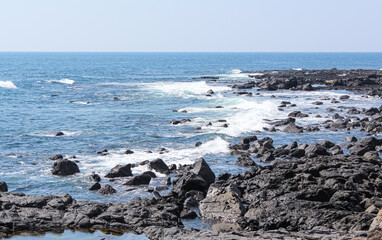 Waves crashing on rocks. good weather day.

