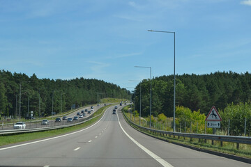 Freeway in the suburban part of Vilnius, Lithuania. Sign warning about the sudden appearance of animals on the road.
