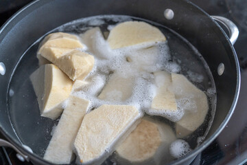 Slices of Yam boiling in a pot for lunch