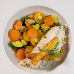 Fish recipe, fillet of sea bass with small vegetables, High quality photo