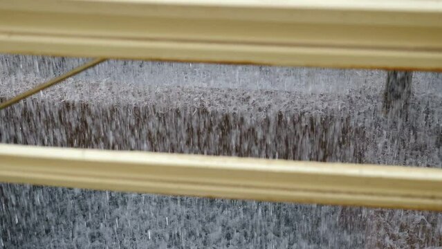 Water inside cooling tower. Inside view. Water droplets inside cooling tower in factory. Water Coolant Dripping From Industrial Processing Machine For Stone Work. Water Drops From Processing Machine