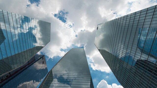 Business and finance concept. time lapse. view looking up at modern office building. Cloudy slow moving Beautiful skyin the yeouido financial district, Seoul,South Korea.