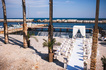 Outdoor wedding ceremony on the blue sea