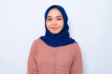 Closeup of smiling young Asian Muslim woman in casual shirt looking at camera isolated over white background. People religious lifestyle concept