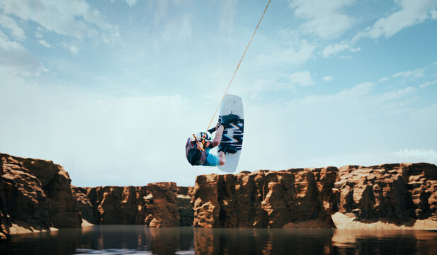 Wakeboarder making tricks on the river. Wakeboarding. Water sports. - Powered by Adobe