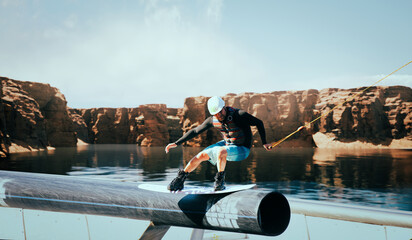 Wakeboarder making tricks on the river. Wakeboarding. Water sports.