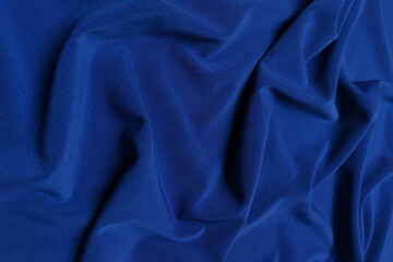 Blue crepe satin crumpled or wavy fabric texture background. Abstract linen cloth soft waves. Silk...