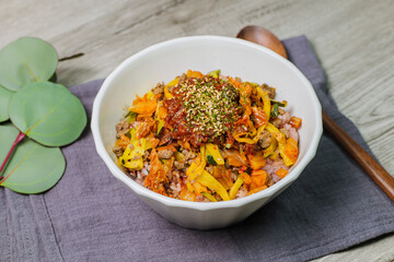Korean food Bibimbap, Rice topped with sautéed beef and a variety of colorful vegetables that is mixed at the table with spicy gochujang. A hint of sesame oil helps bring out the flavor.