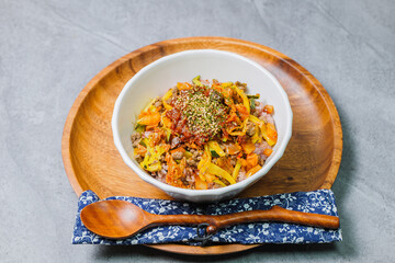 Korean food Bibimbap, Rice topped with sautéed beef and a variety of colorful vegetables that is mixed at the table with spicy gochujang. A hint of sesame oil helps bring out the flavor.