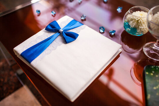White wedding guest book on a wooden table