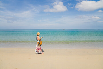 Asian women stand on the beach. Phuket Sea Beach, Mai Khao Beach, Thailand