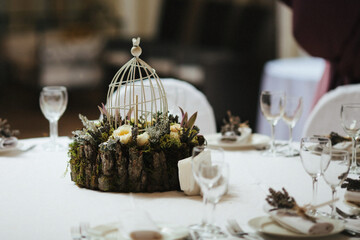 Bouquet of flowers in cage on the wedding table