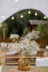 Bouquet of flowers in vase on the wedding table
