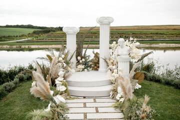 Arch for outdoor wedding ceremony with flowers