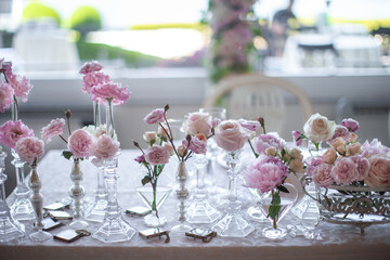 Bouquets of flowers in vase on the wedding table