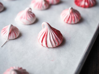 red and white meringue cookie in kiss shape