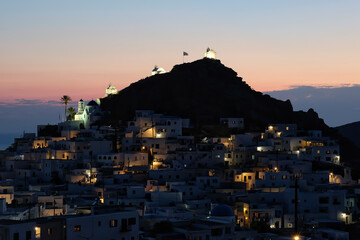 Panoramic view of the picturesque illuminated island of Ios in Greece while the sun is setting