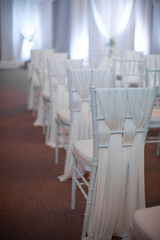Wooden chairs for an outdoor wedding ceremony
