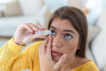 Woman using eye drop, woman dropping eye lubricant to treat dry eye or allergy, sick woman treating...