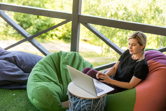 Work from home or study online, concept with a woman working at laptop outdoor on terrace