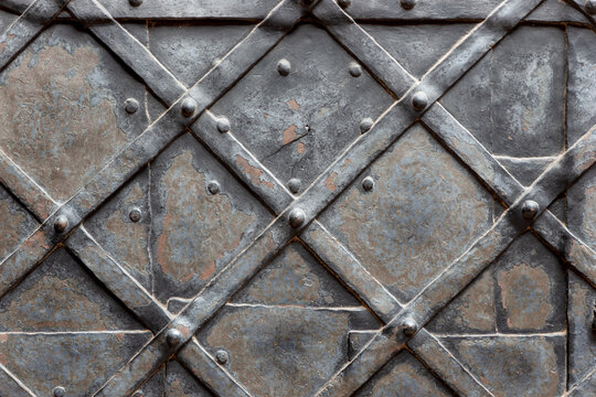 Old metal door background. Decorated with geometric patterns and metal stripes