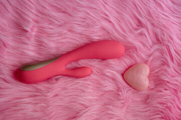 pink vibrator sex toy with hearts on pink background, love on valentines - obrazy, fototapety, plakaty