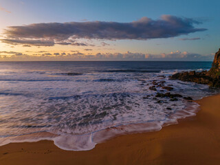 Aerial sunrise at the beach with clouds
