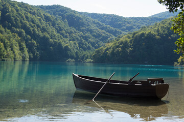 Fototapeta na wymiar boat on the lake,mountains in the background