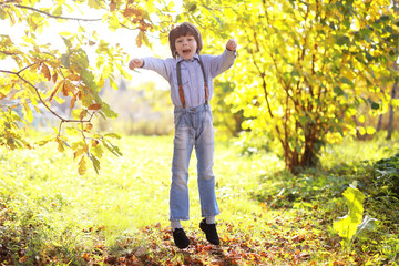 Young family on a walk in the autumn park on a sunny day. Happiness to be together.