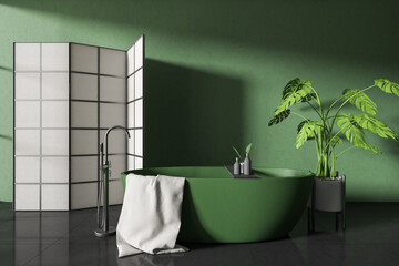 Front view on dark bathroom interior with bathtub, partition, plant