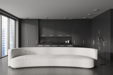 Grey studio interior with relax area and kitchen appliances, panoramic window © ImageFlow